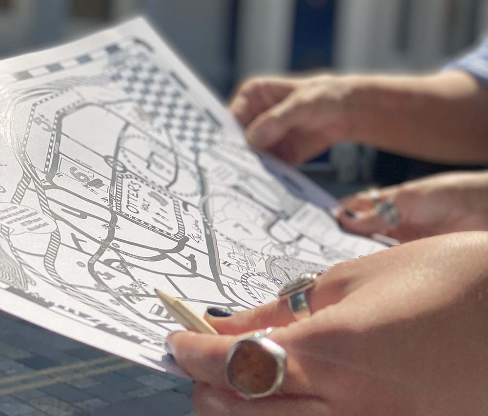 The Quest trail map held in a players hands in Bristol city centre